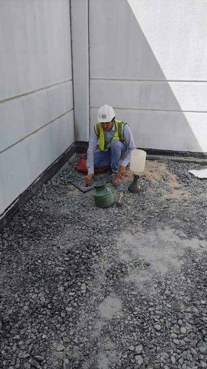 Worker collecting material samples for laboratory testing